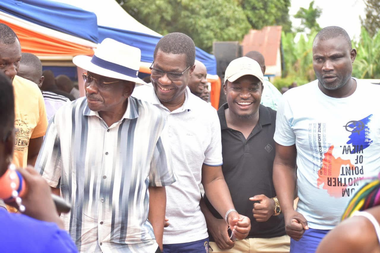 Dan Moen Nyibule with community members at an outdoor event in Ugunja